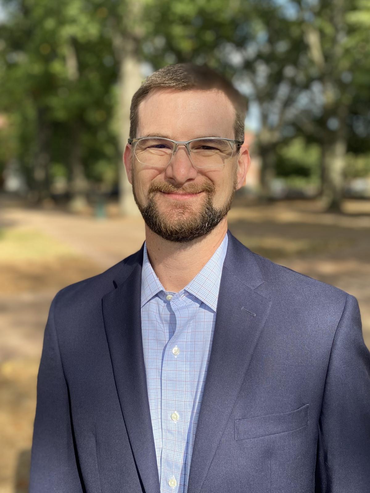 headshot of man in glasses outside