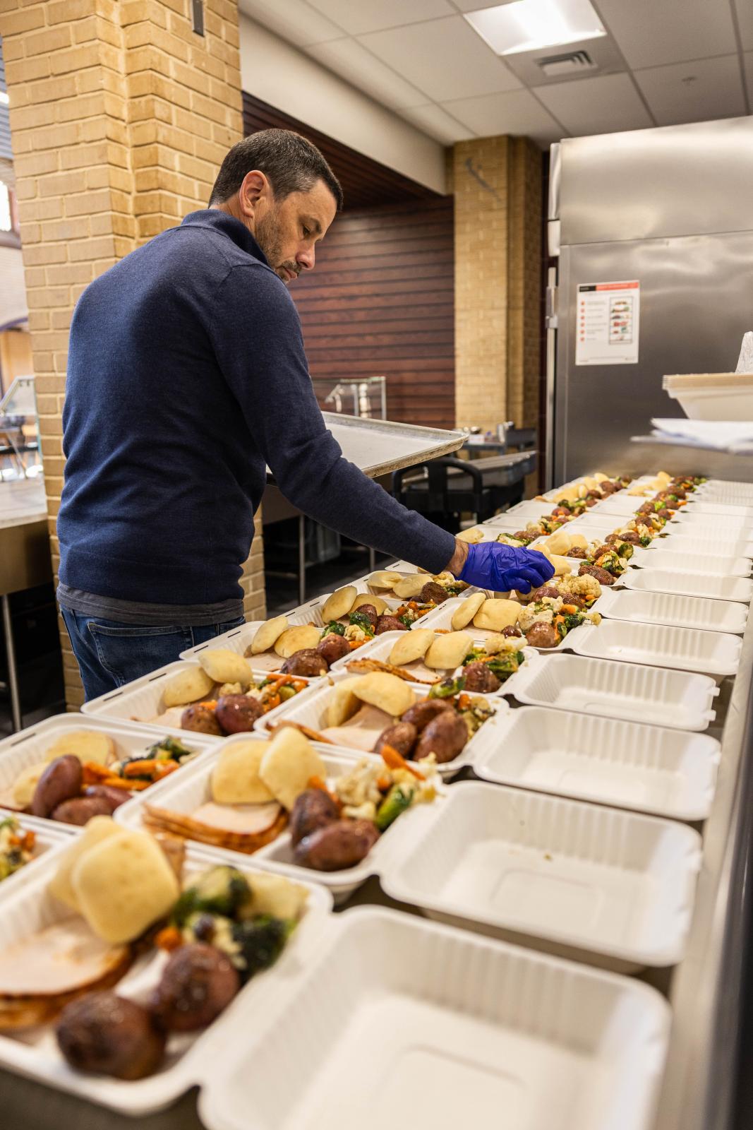 Mississippi State University Dining Services Resident District Manager James Jankowski prepares Thanksgiving boxes for distribution to MSU students in November.