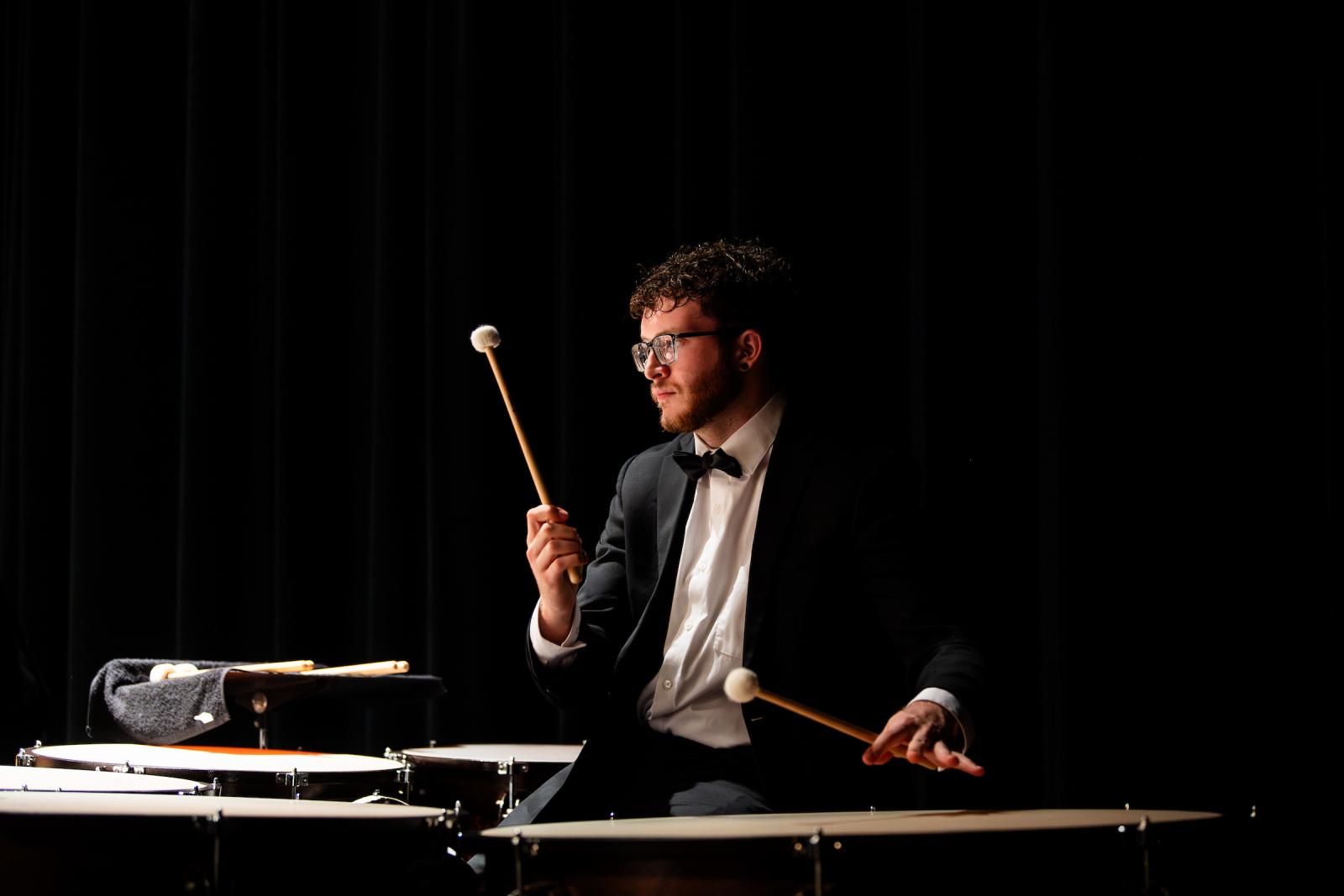 person playing an instrument on black backround