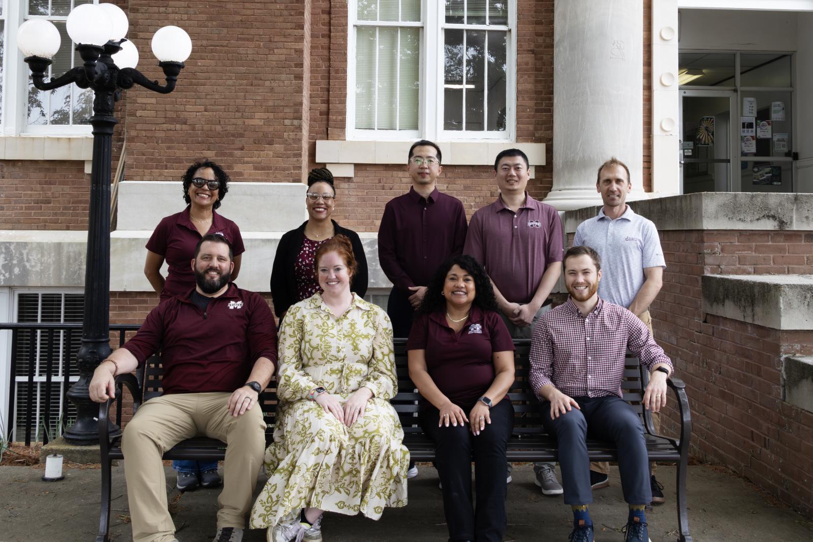 Photo of MSU faculty in front of a building