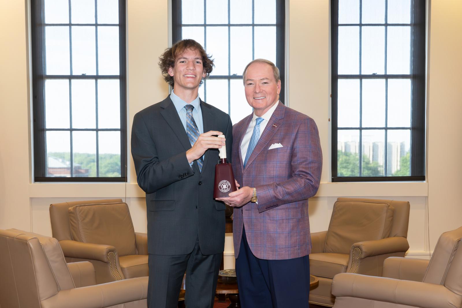 MSU president presents Truman Scholar Evan Garrison with cowbell