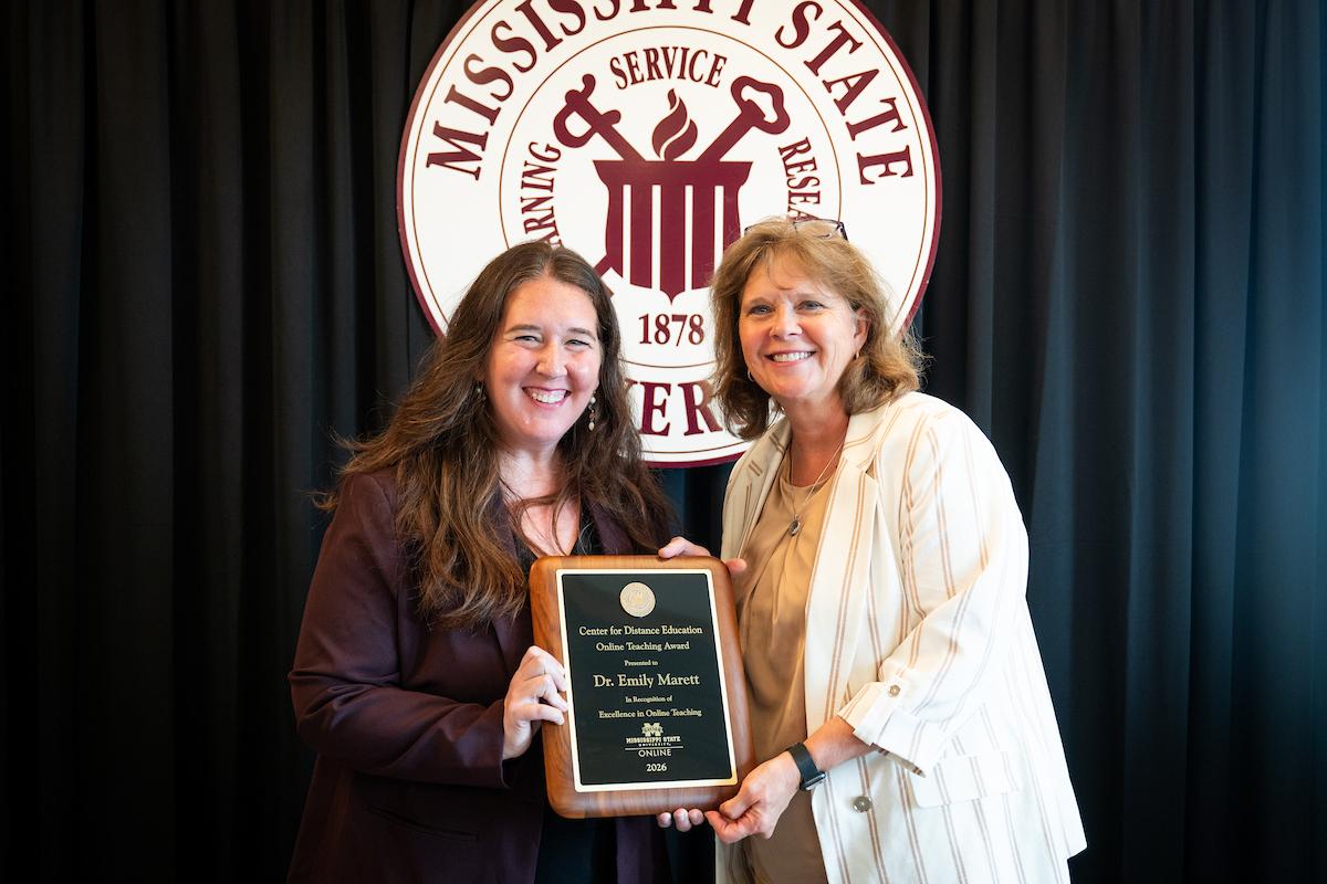 MSU Dean of the College of Professional and Continuing Studies Susan Seal, left, presents the Online Teaching Excellence Award to Emily Marett.