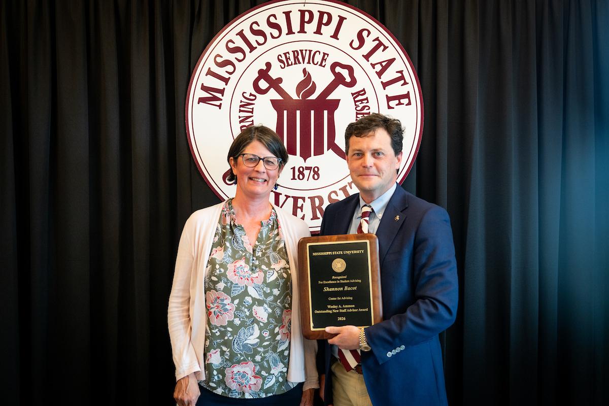 MSU Interim Associate Vice President for Strategic Partnerships Tabor Mullen, left, presents the Wesley A. Ammon Outstanding New Staff Advisor Award to Shannon.