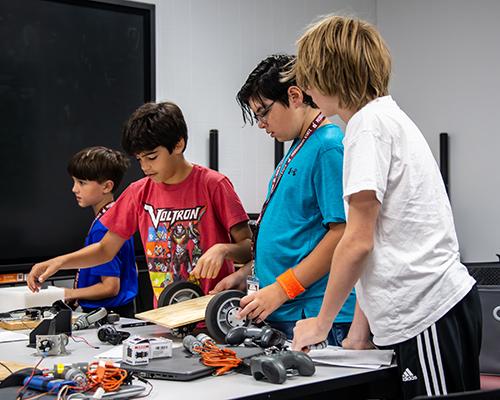 Campers assemble a robot during Mississippi State’s Inspiring New Design and Technology Robotics Camp last summer.