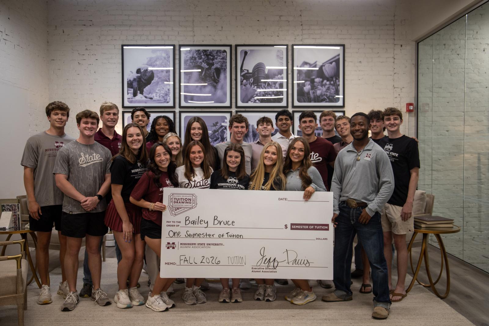 photo of MSU alumni delegates celebrate the tuition drawing winner Bailey Bruce