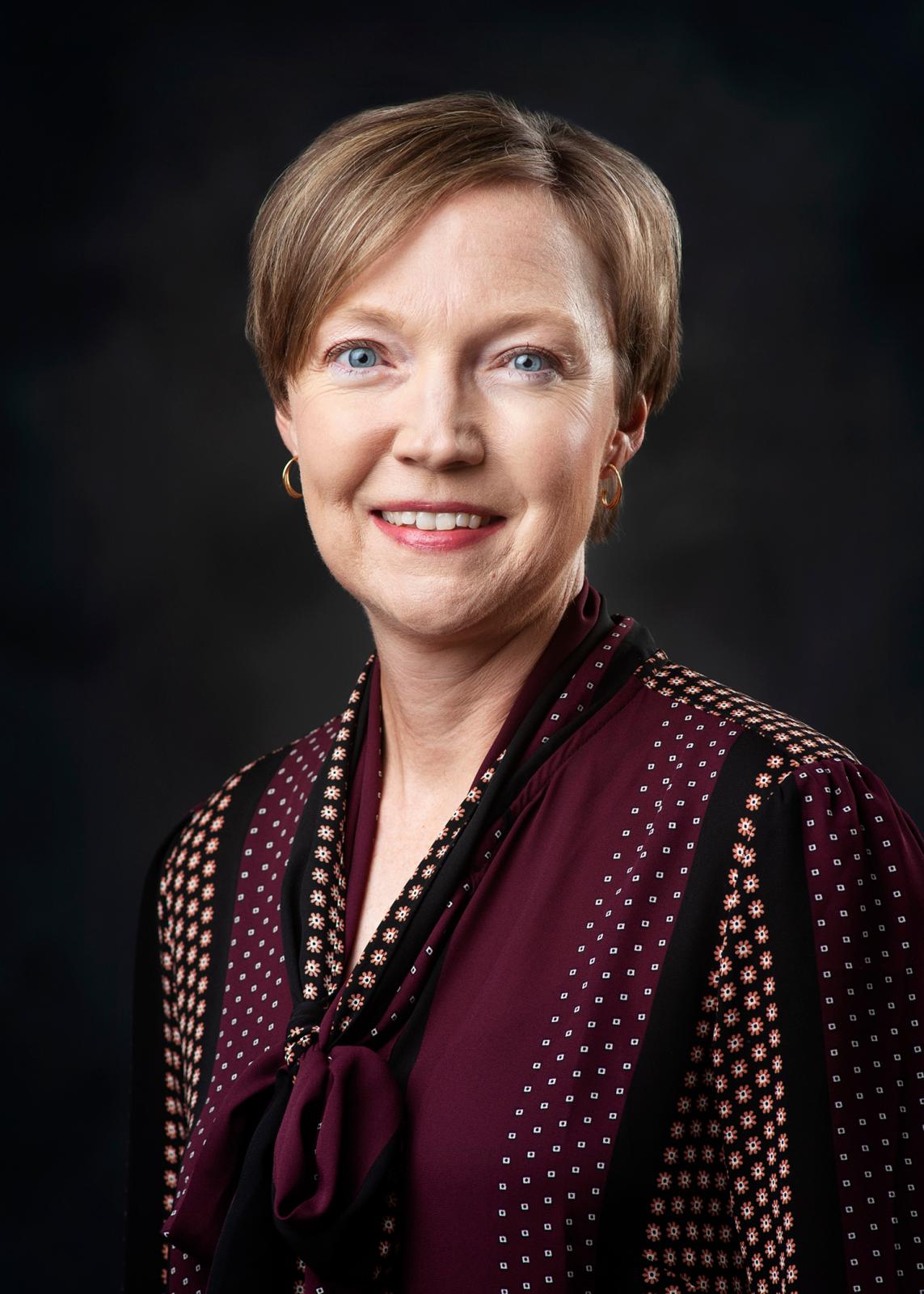 Headshot of Stephanie King on a black background