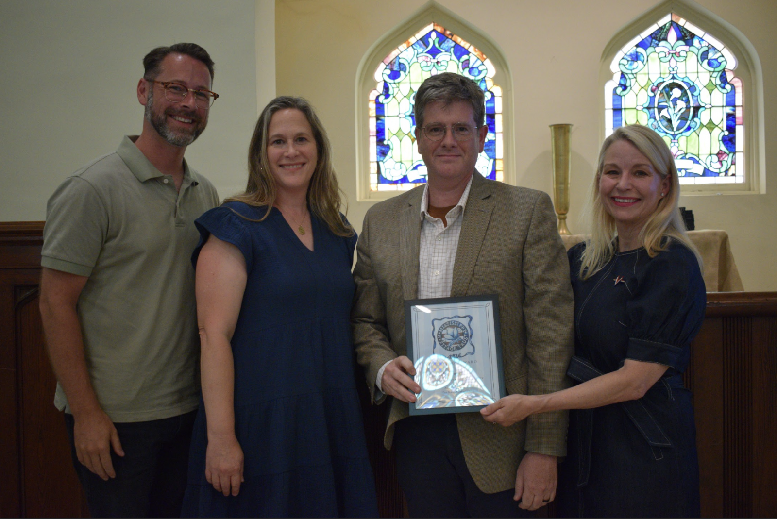Photo of two men and two women receiving an award