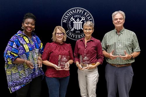 The following, pictured from left, were presented with the Regions Bank–DAFVM Superior Faculty Awards: Caroline Kobia, Mississippi State Department of Human Sciences associate professor; Jamie Larson accepting on behalf of David Wise, Delta Research and Extension Center research professor; Leslie Burger, Department of Wildlife, Fisheries and Aquaculture associate teaching professor; and Jimmy Avery, DREC Extension professor and USDA NIFA Southern Regional Aquaculture director. (Photo by Michaela Parker)
