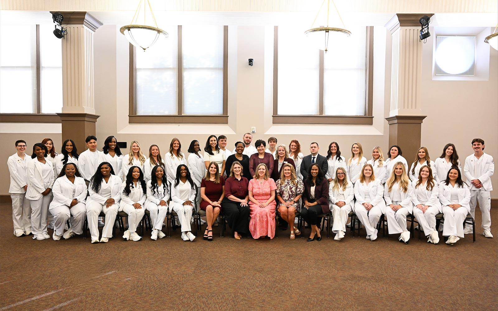 The 2026 MSU Master of Science in Nursing graduating cohort, pictured with MSU School of Nursing faculty leaders at the MSU-Meridian Riley Campus before their commencement ceremony.
