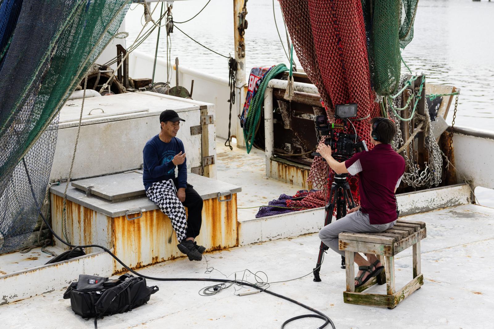 MSU film producer James Parker interviews a fisherman on a shrimp boat