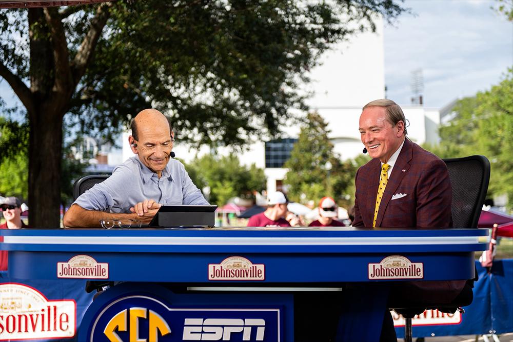 MSU President Mark Keenum, right, and football commentator Paul Finebaum speak on the set of an SEC Network broadcast.