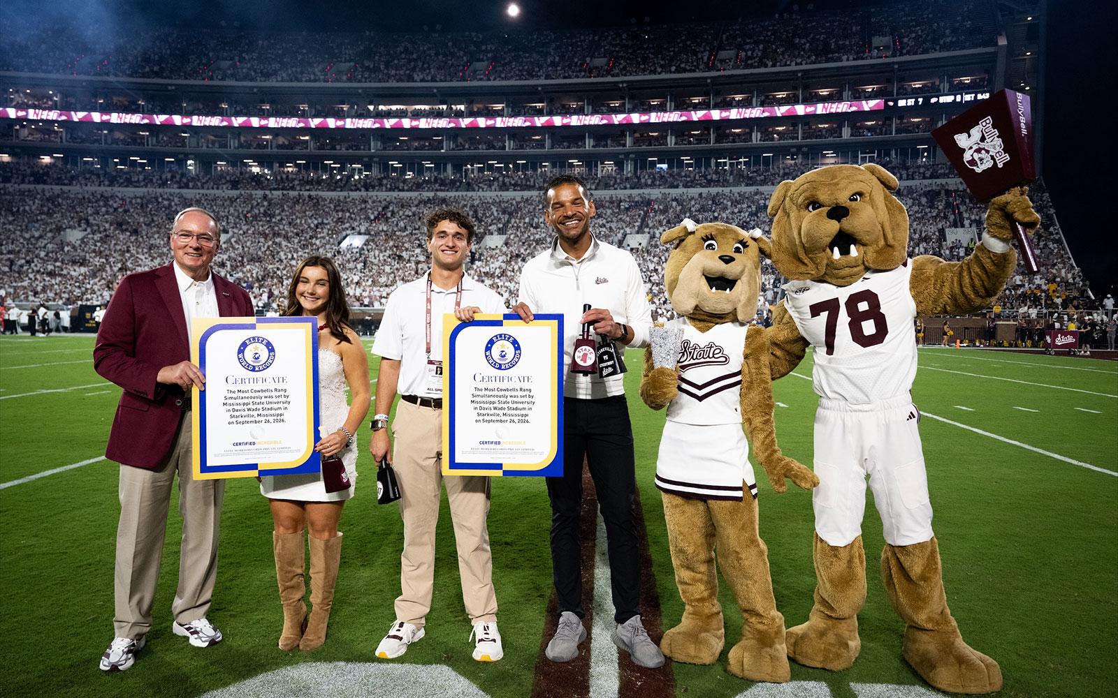 MSU President Mark E. Keenum, from left, MSU Student Association Cowbell Commissioner Miles Jordan, SA President Keegan Figueroa, MSU Director of Athletics Zac Selmon, along with mascots Belle and Bully, celebrate the Bulldogs’ new world record for most cowbells ringing simultaneously at Davis Wade Stadium Sept. 26.