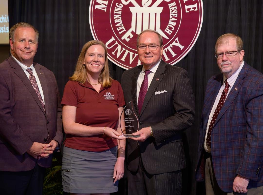 photo of MSU VPs and president with award winner Amy Dapper
