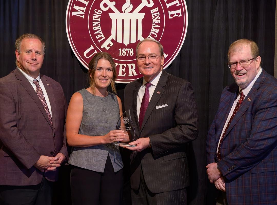 photo of MSU VPs and president with award winner Beth Baker