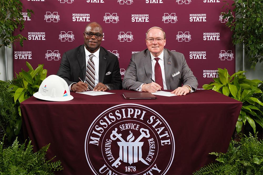 Mississippi Power Chairman, President and CEO Pedro Cherry, left, and Mississippi State University President Mark E. Keenum, sign a memorandum of understanding